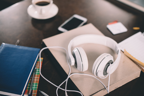 Book and headphones on table - 写真・画像