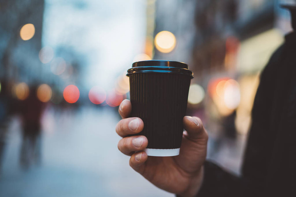 Male hand holding coffee cup  - Foto, afbeelding