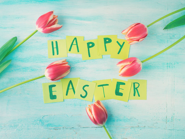 Happy Easter background tulips flowers hand written letters - Фото, изображение