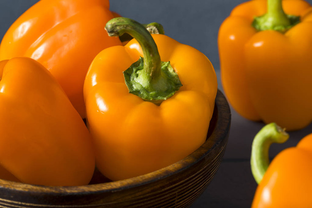 Raw Organic Orange Bell Peppers - 写真・画像
