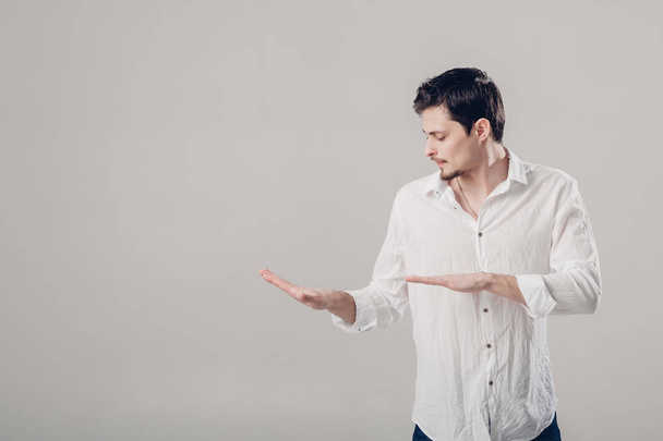 handsome young man in  white shirt dancing and having fun on gre - Fotoğraf, Görsel