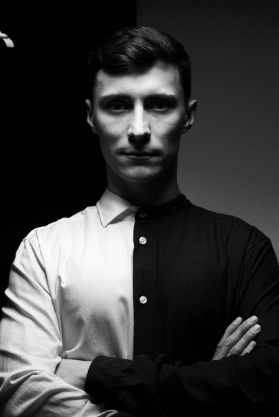 Low key portrait of a man in different shirts in black and white. - Foto, Bild