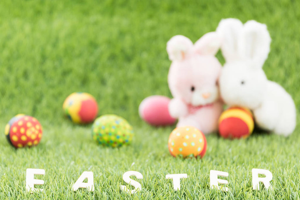 Bunny toys and Easter eggs with text - Fotoğraf, Görsel
