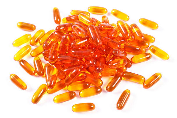 Orange medical capsules on white background, health care concept - Фото, изображение