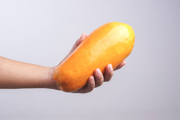 Hand holding ripe papaya - Φωτογραφία, εικόνα