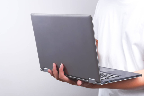 Hand holding laptop - Фото, изображение