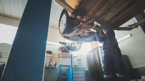 Araba garaj mekanik atölye - otomobil hizmetinde ayakta kaldırdı otomatik mekanik kontrol altına - Fotoğraf, Görsel