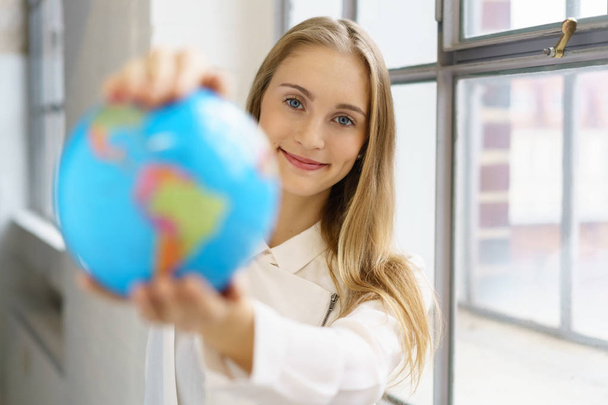 woman holding globe in hands - Foto, imagen