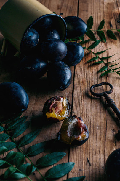 Fresh plums on rustic  table - Fotó, kép