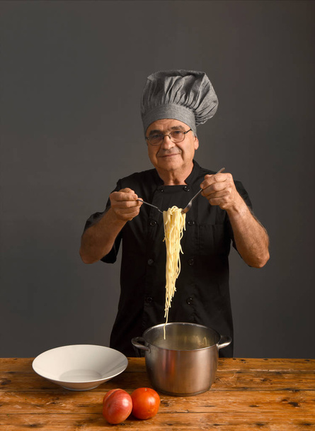 portrait of  senior Chef on grey - Photo, Image