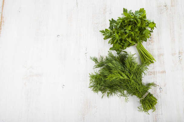 Parsley and dill on a light wooden background. - Foto, immagini
