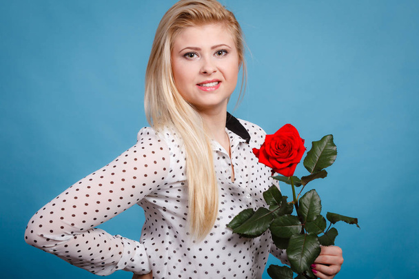 Woman holding red rose flower on blue - Photo, image