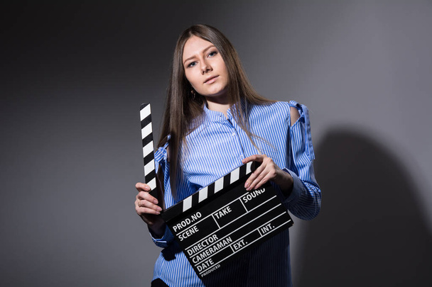 Close-up of a girl with a movie clapper - Fotografie, Obrázek