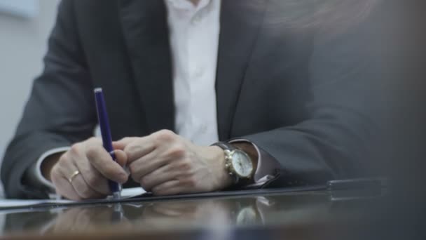 man in suit sitting at shiny table  - Felvétel, videó