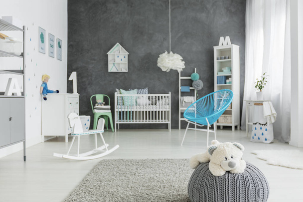 Child room with grey pouf - 写真・画像
