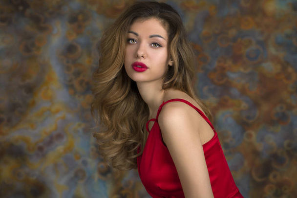 Young beautiful blonde woman in red dress - 写真・画像
