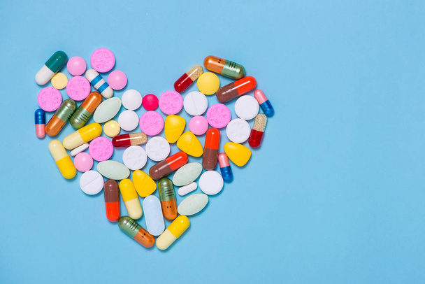 Colored pills in heart shape - Fotó, kép