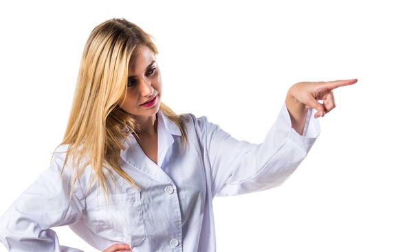 Doctor woman pointing to the lateral - Photo, Image