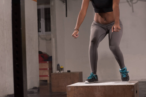 black woman is performing box jumps at gym - Φωτογραφία, εικόνα