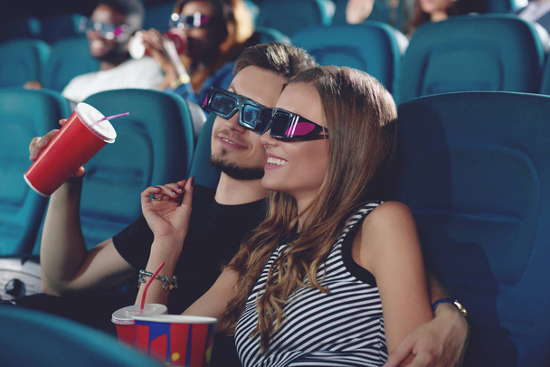 Boyfriend and gifrliend in modern cinema watching film. - Фото, изображение
