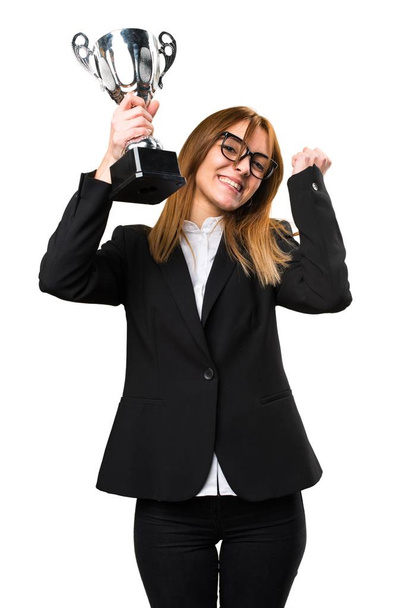 Young business woman holding a trophy - Фото, изображение