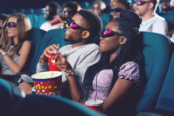 Boyfriend and girlfriend in 3d glasses watching movie in cinema. - Foto, afbeelding