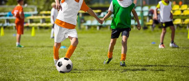 Futbol eğitim çocuk. Genç erkek futbol maçı sahada oynuyor. Futbol topu ile çalışan çocuklar. Futbol eğitim oturumu çocuklar için - Fotoğraf, Görsel