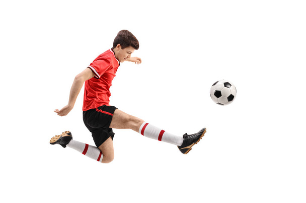 Teenage soccer player kicking a football - Foto, Imagen