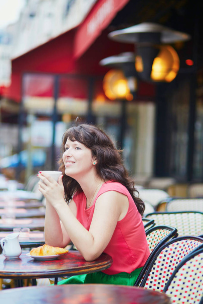 Woman drinking coffee in cafe - Фото, изображение