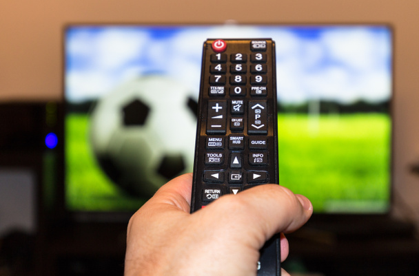 Football match and remote control - Photo, Image