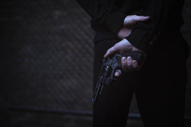 Man covering weapon behind back - Фото, зображення