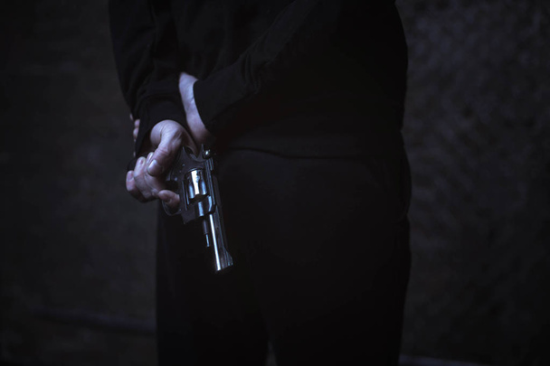 Man covering weapon behind back - Fotó, kép