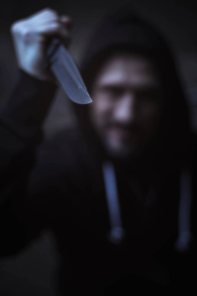 Dangerous criminal holding up knife  - Photo, image