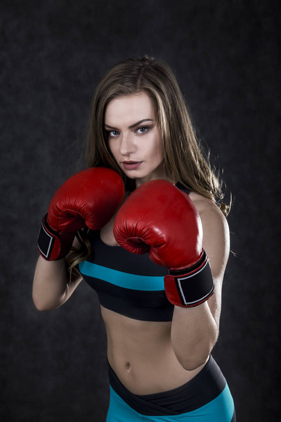 Serious boxing woman in red box gloves - Фото, изображение