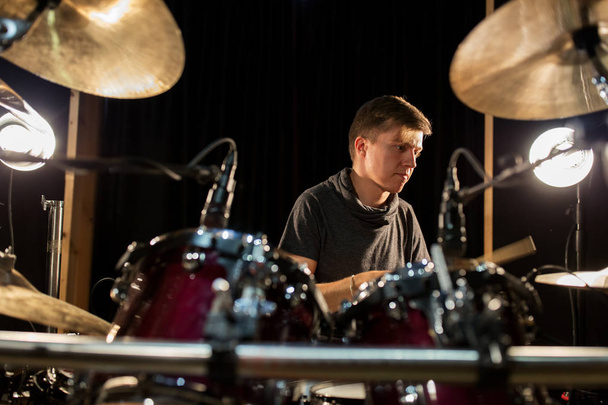 male musician playing drums and cymbals at concert - Foto, Imagen
