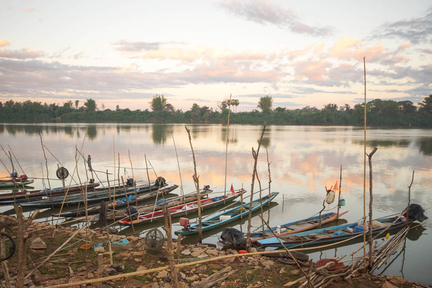 Kuu-joelle pysäköidyt pienten veneiden rivit
 - Valokuva, kuva