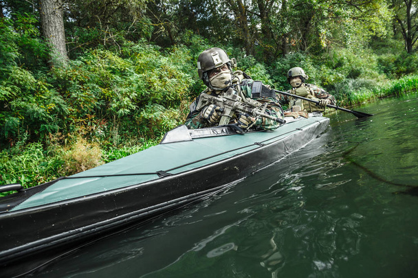 Militants in army kayak - Photo, Image