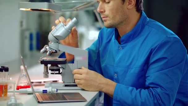 Male scientist looking microscope in lab. Microscope laboratory research - Footage, Video