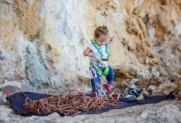 Little girl  playing with rock climbing equipment  - Photo, Image