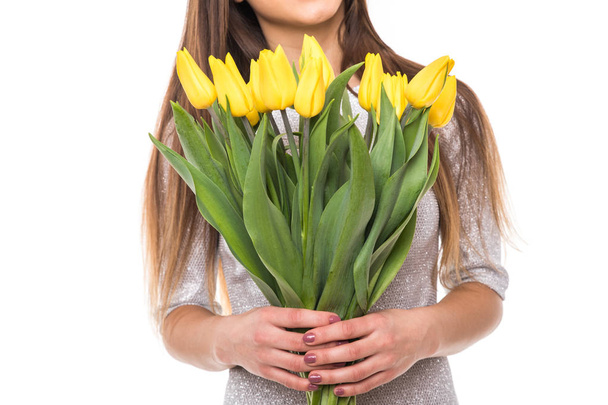 Close up of Happy woman in dress with yellow tulips isolated on white background - Фото, изображение