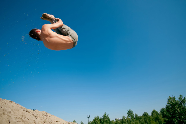 Excited young man jumping in air - Photo, Image