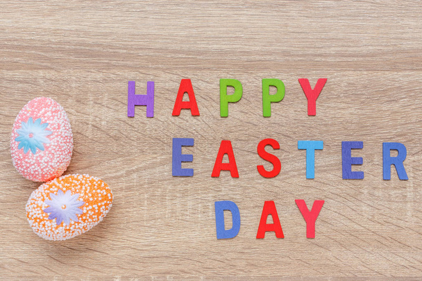 Artificial color eggs on wooden plank background. For Easter day - Fotografie, Obrázek