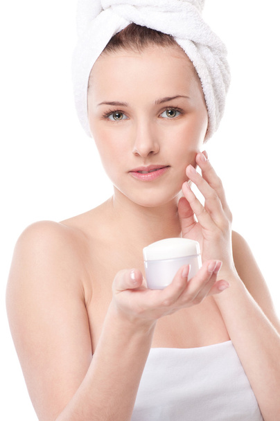 Woman applying moisturizer cream on face - Fotografie, Obrázek