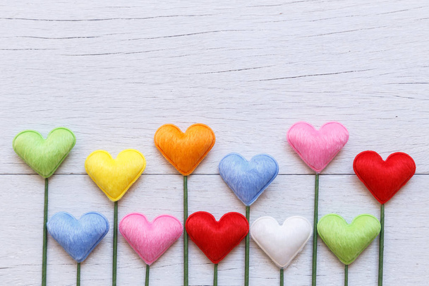Colorful heart shape on white wooden plank background. For love  - Fotoğraf, Görsel