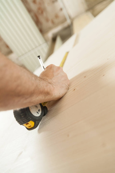 woodworker artisan in his workshop measuring - Photo, Image