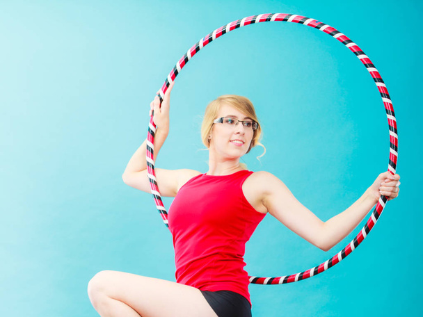 Fit woman with hula hoop doing exercise - Фото, изображение