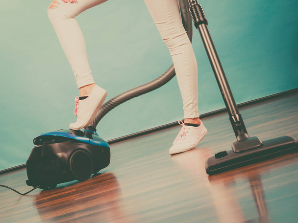Woman legs and vacuum cleaner - Foto, Imagen