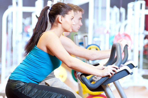 in the gym doing cardio cycling training - 写真・画像