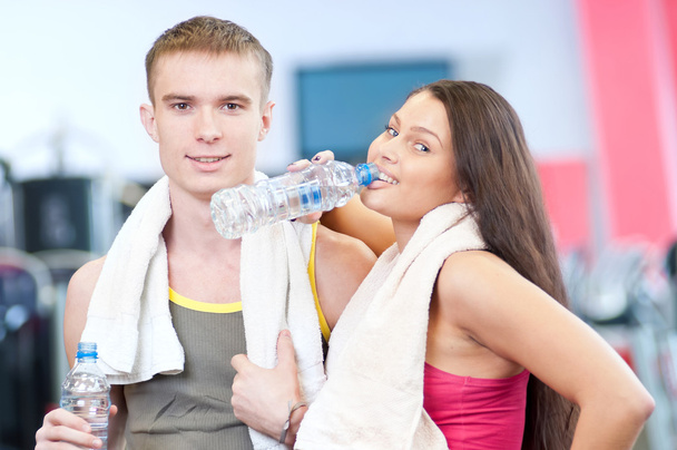 Man and woman drinking water after sports - Photo, image