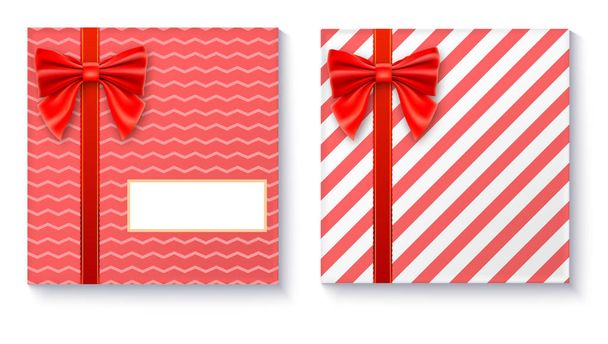 Gift boxes with big red bow and ribbon on white background. - Vektori, kuva